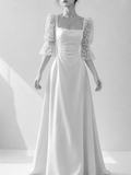 White wedding dress with a lace shrug on a white background