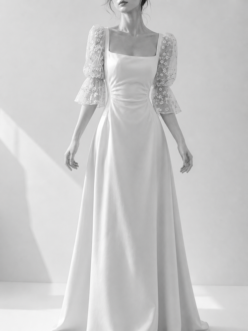 White wedding dress with a lace shrug on a white background
